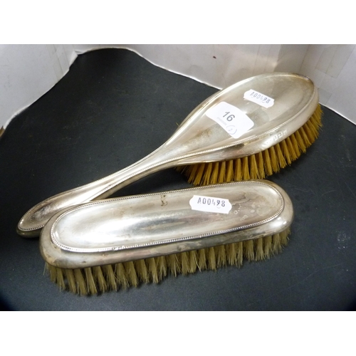 16 - Silver-backed lady's brush and a matched silver-backed clothes brush.  (2)