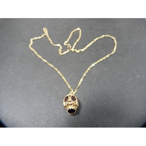 54 - 9ct gold chain with 9ct gold and garnet-style pendant, 10.4g gross.