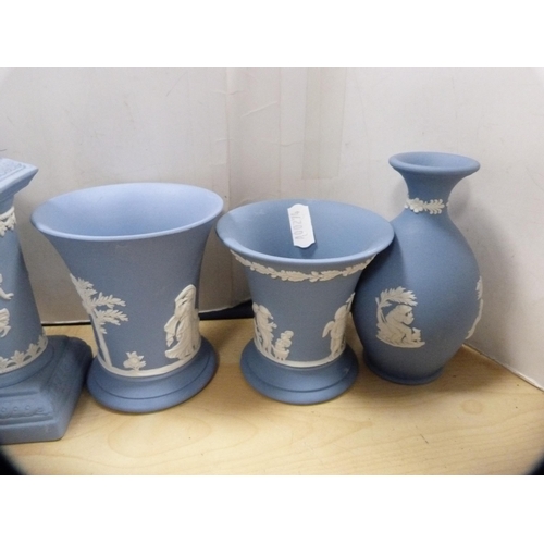 68 - Group of Wedgwood blue Jasper ware to include a clock case, oval plaques, spill vases, pin dishes et... 