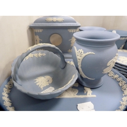 68 - Group of Wedgwood blue Jasper ware to include a clock case, oval plaques, spill vases, pin dishes et... 