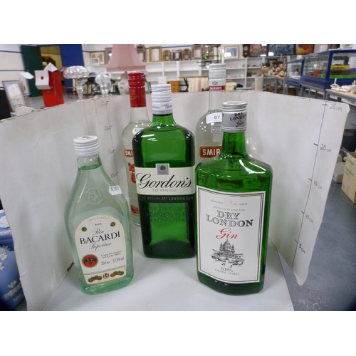 87 - Smirnoff Vodka, 70cl and 1 litre, Gordon's Gin, 1 litre, London Dry Gin, 70cl, and a half bottle of ... 