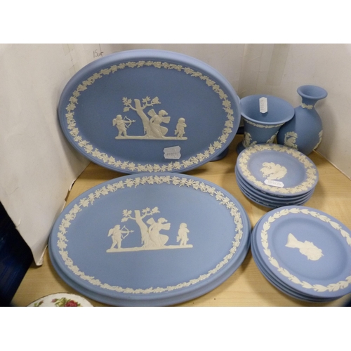 68 - Group of Wedgwood blue Jasper ware to include a clock case, oval plaques, spill vases, pin dishes et... 