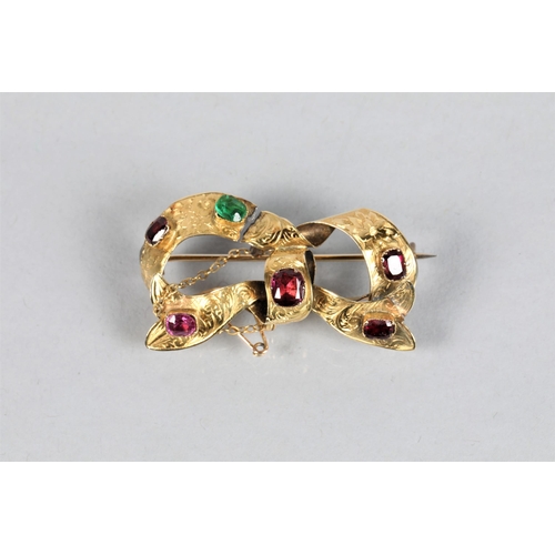 64 - Unmarked yellow metal and multi stone set 'bow' brooch; 4.5cm wide