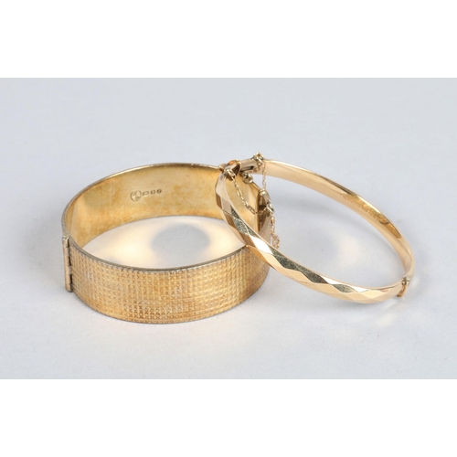 75 - Hallmarked silver hinged bangle; 49.1g gross weight together with one bangle