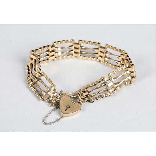 76 - 9 carat yellow gold gate bracelet; with a heart shaped clasp; 12g gross weight