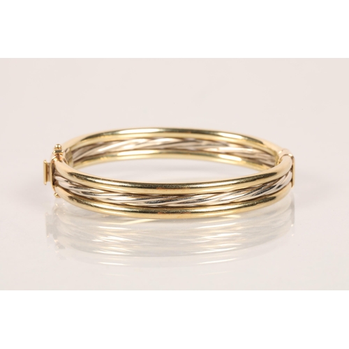 101 - 9 carat bi - coloured ladies hinged bangle; 23g gross weight