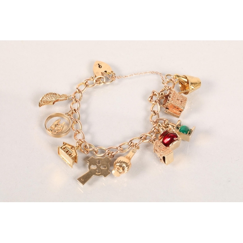 102 - Ladies 9 carat yellow gold charm bracelet with ten 9 carat yellow gold charms; 45.3g gross weight