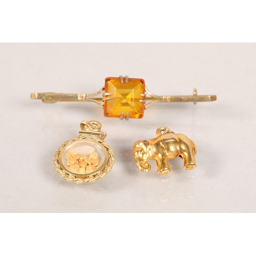 111 - 9 carat yellow gold elephant charm; 9 carat yellow gold 'laurel reef' charm and a Art Deco set bar b... 