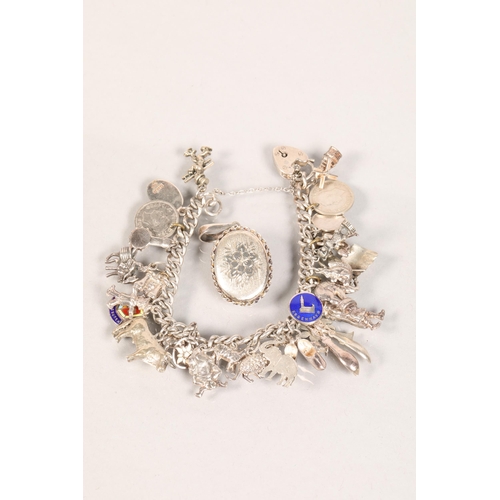 114 - Ladies silver charm bracelet; with many charms; 71g gross weight