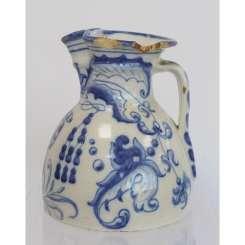 220 - Spanish Talavera de la Reina tin glazed blue and white jug of domed form with trefoil rim, decorated... 