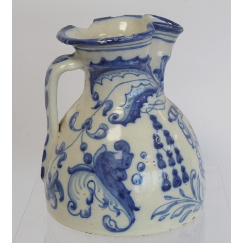 220 - Spanish Talavera de la Reina tin glazed blue and white jug of domed form with trefoil rim, decorated... 