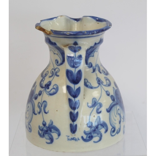 220 - Spanish Talavera de la Reina tin glazed blue and white jug of domed form with trefoil rim, decorated... 