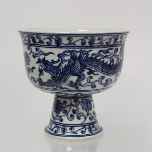 227 - 20th century Chinese blue and white stem cup decorated with a scrolling dragon amongst flowers and f... 