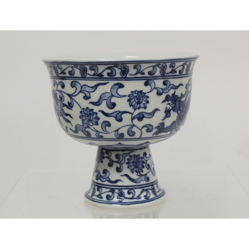 227 - 20th century Chinese blue and white stem cup decorated with a scrolling dragon amongst flowers and f... 