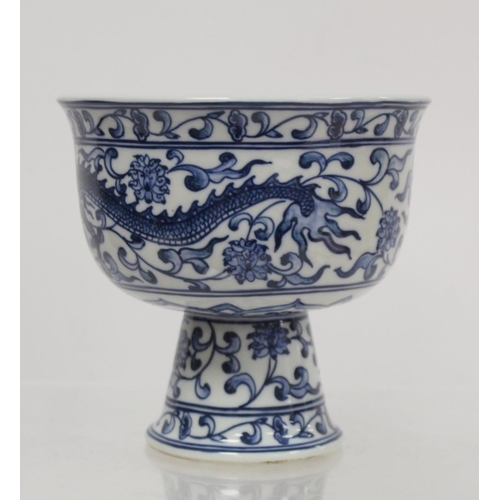 227 - 20th century Chinese blue and white stem cup decorated with a scrolling dragon amongst flowers and f... 