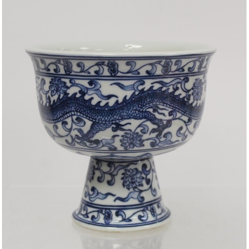 227 - 20th century Chinese blue and white stem cup decorated with a scrolling dragon amongst flowers and f... 