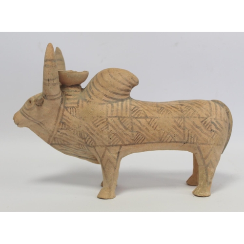 233 - Antique Eastern terracotta votive figure of a zebu (humped) bull with painted monochrome geometric d... 