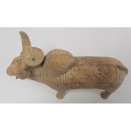 233 - Antique Eastern terracotta votive figure of a zebu (humped) bull with painted monochrome geometric d... 