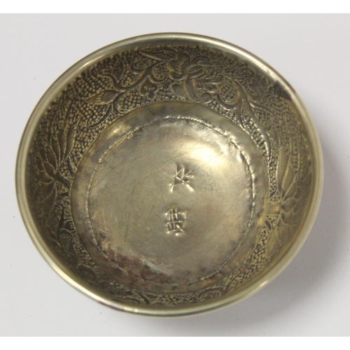 236 - Chinese small white metal bowl with repousse floral band to exterior and two punched character marks... 