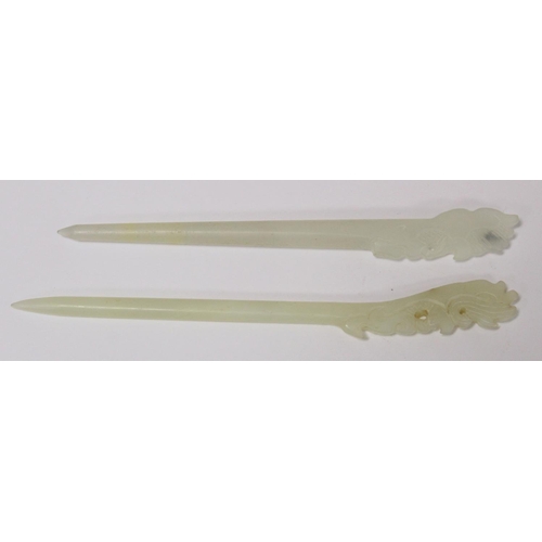 239 - Two Chinese pale celadon jade hair pins, each with pierced and carved ends, 17cm and 16cm long. ... 