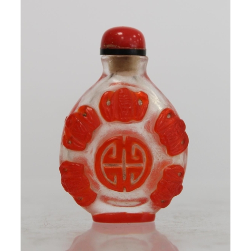 243 - Chinese glass red overlay snuff bottle carved with lucky bats and auspicious symbols, 6cm high.