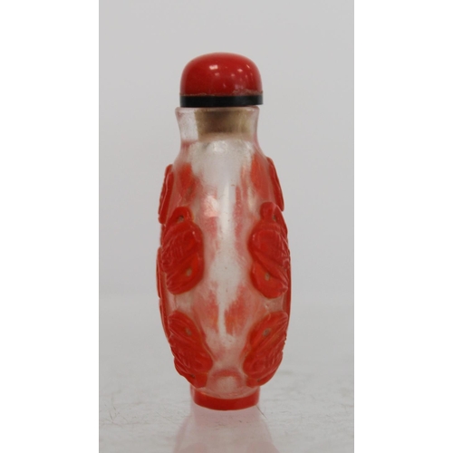 243 - Chinese glass red overlay snuff bottle carved with lucky bats and auspicious symbols, 6cm high.