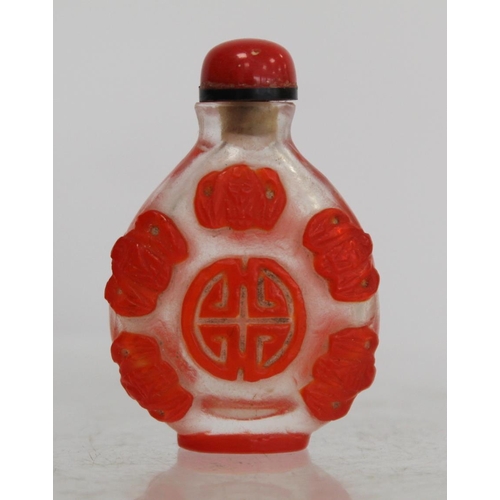 243 - Chinese glass red overlay snuff bottle carved with lucky bats and auspicious symbols, 6cm high.