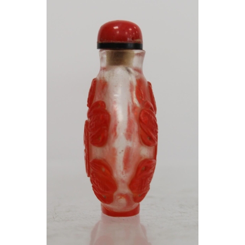 243 - Chinese glass red overlay snuff bottle carved with lucky bats and auspicious symbols, 6cm high.