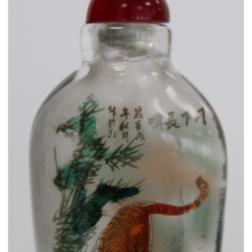 244 - Chinese glass snuff bottle of flattened ovoid form internally decorated with figures of two tigers a... 