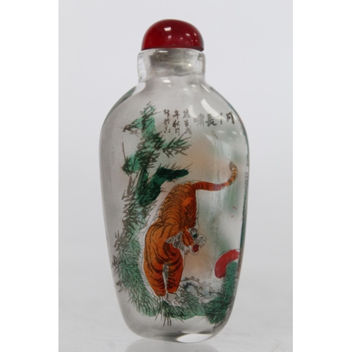 244 - Chinese glass snuff bottle of flattened ovoid form internally decorated with figures of two tigers a... 