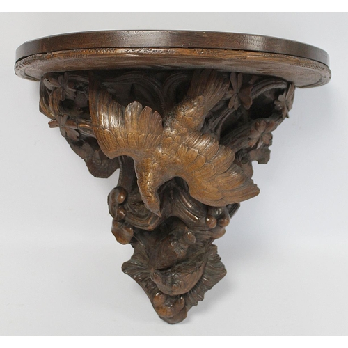 248 - Pair of Victorian or Edwardian walnut wall brackets, the demi lune tops on tapered supports profusel... 