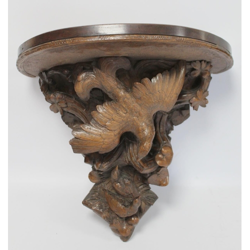 248 - Pair of Victorian or Edwardian walnut wall brackets, the demi lune tops on tapered supports profusel... 