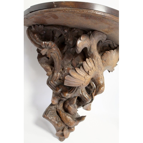 248 - Pair of Victorian or Edwardian walnut wall brackets, the demi lune tops on tapered supports profusel... 