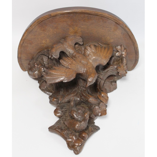 248 - Pair of Victorian or Edwardian walnut wall brackets, the demi lune tops on tapered supports profusel... 