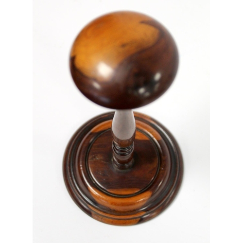 251 - 19th century treen wig stand, possibly yew or fruitwood, the domed circular top on tapered knopped b... 