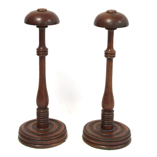 252 - Pair of 19th century oak wig stands, with domed tops on turned knopped baluster stems and turned cir... 