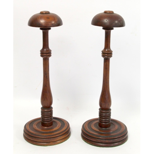 252 - Pair of 19th century oak wig stands, with domed tops on turned knopped baluster stems and turned cir... 