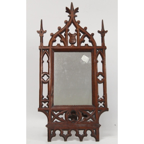 254 - Victorian small dressing table mirror, the rectangular glass in pierced and carved walnut gothic fra... 