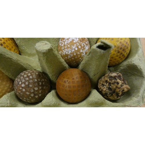 116 - Three antique golf balls including two mesh and one original gutty (a/f) and others.