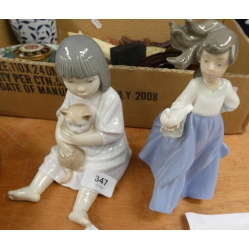 347 - Two Nao figures, girl with a cat and girl holding a dove.