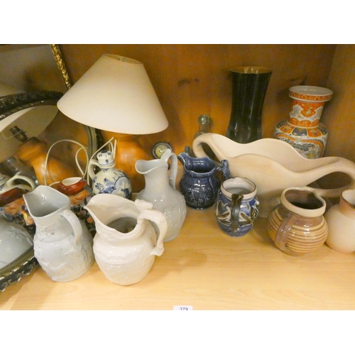 379 - Bay of collectable jugs, mirror etc.