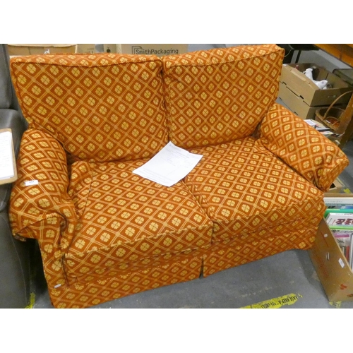 444 - Orange and gold two seater sofa.