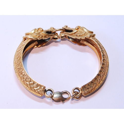 101 - Chinese gold bracelet in two halves, modelled as dragons grasping a ring, Chinese character and othe... 