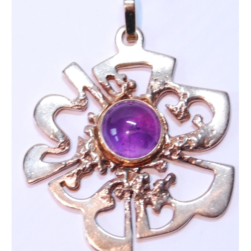 111 - 9ct gold openwork pendant with cabochon amethyst, 16.2g gross.