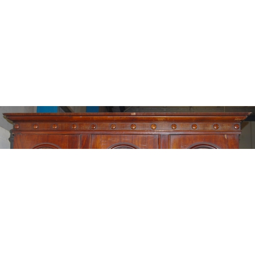 409 - Victorian mahogany library bookcase with Gothic-influenced roundels to the shaped cornice above thre... 