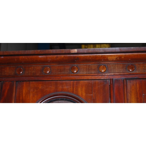 409 - Victorian mahogany library bookcase with Gothic-influenced roundels to the shaped cornice above thre... 