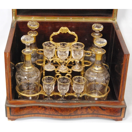 199 - Victorian walnut and ebony strung travelling decanter set, the bi-fold lid enclosing four gilt decor... 