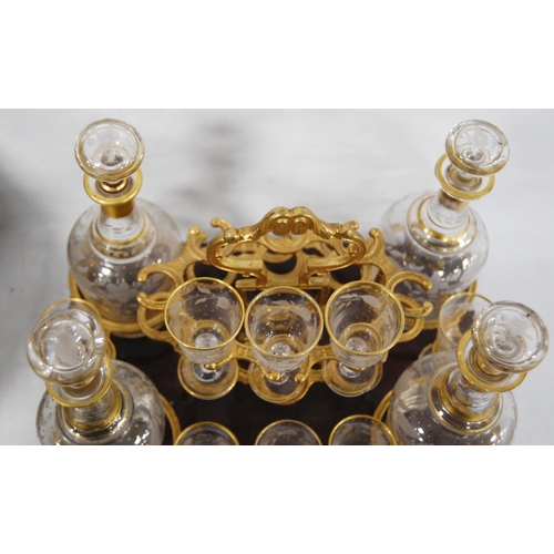 199 - Victorian walnut and ebony strung travelling decanter set, the bi-fold lid enclosing four gilt decor... 