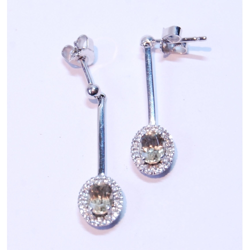 87 - Pair of morganite and diamond drop earrings, each with an oval cluster dependant from a bar.