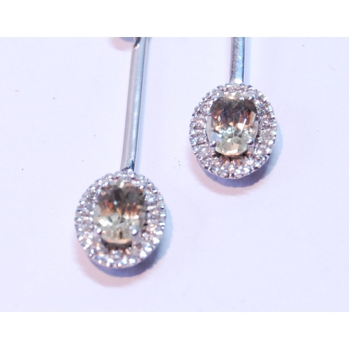 87 - Pair of morganite and diamond drop earrings, each with an oval cluster dependant from a bar.